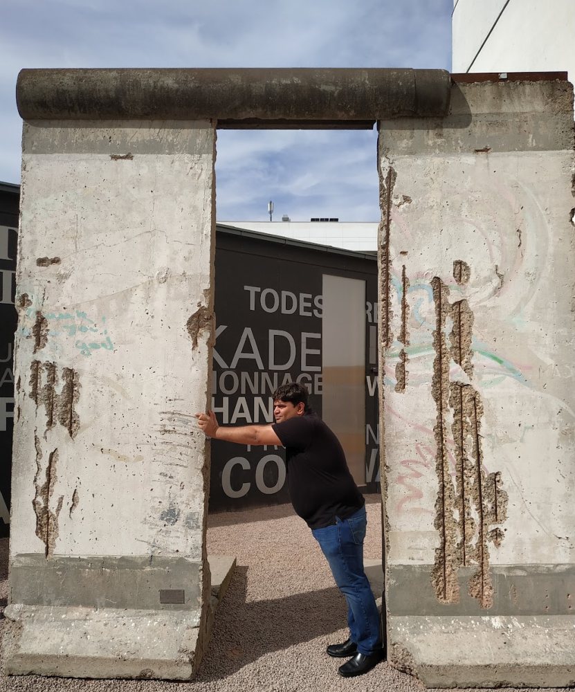 Vishwa Ranjan beside preserved segments of the Berlin Wall
