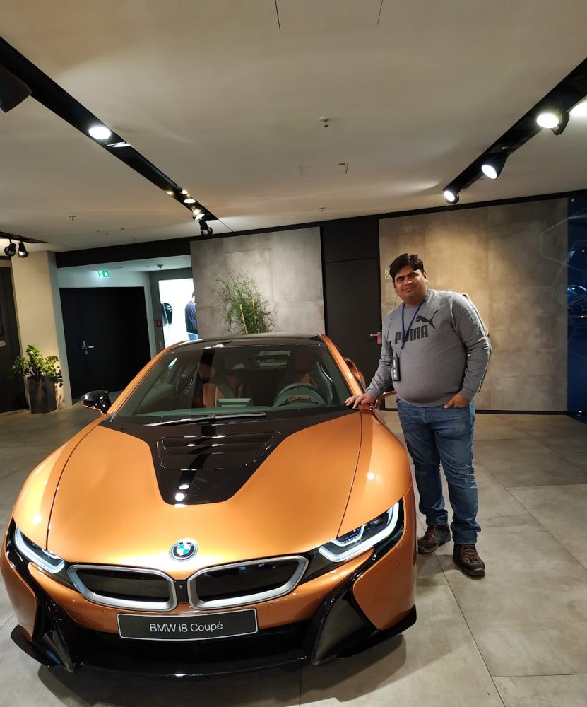 Vishwa Ranjan beside a BMW i8 Coupé