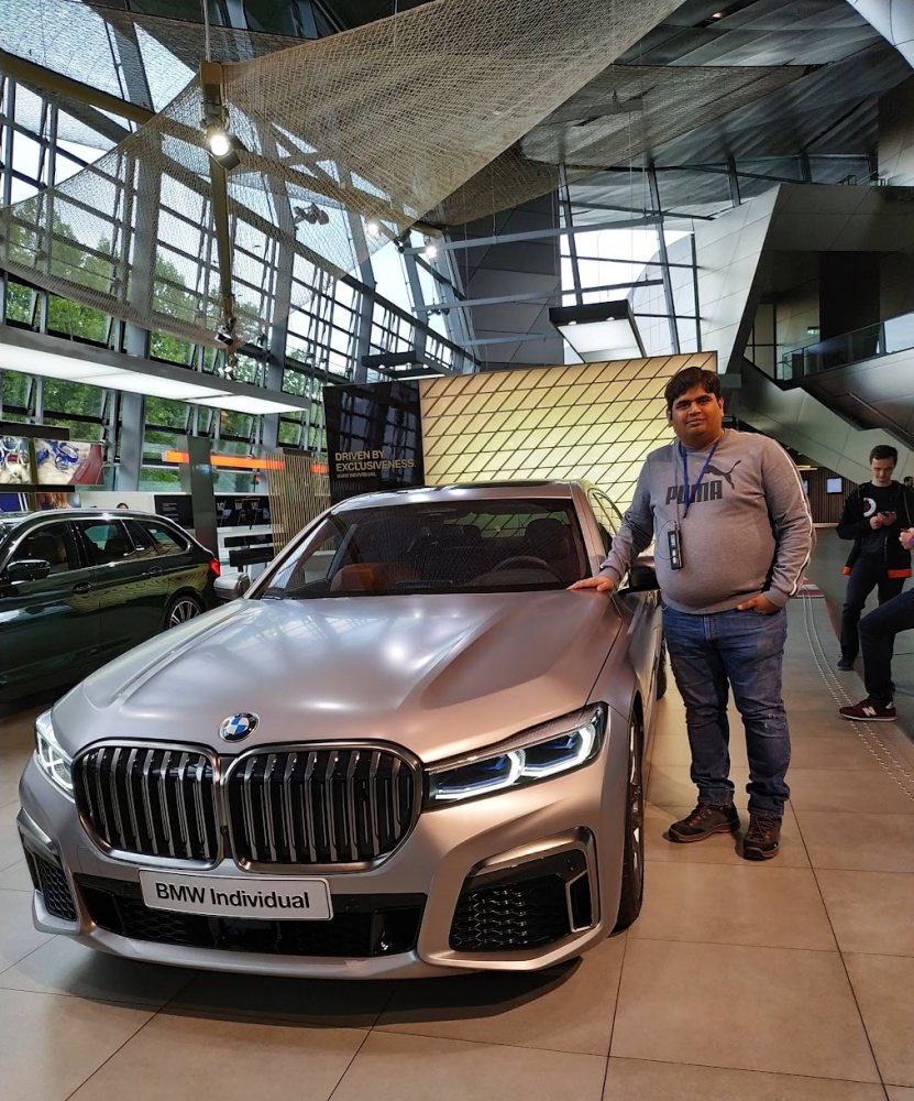 Vishwa Ranjan beside a BMW 7 Series at BMW Welt